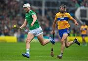 5 June 2022; Kyle Hayes of Limerick races clear of Cathal Malone of Clare during the Munster GAA Hurling Senior Championship Final match between Limerick and Clare at FBD Semple Stadium in Thurles, Tipperary. Photo by Brendan Moran/Sportsfile