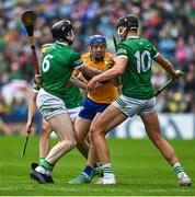 5 June 2022; Shane O'Donnell of Clare is tackled by Declan Hannon and Gearoid Hegarty of Limerick during the Munster GAA Hurling Senior Championship Final match between Limerick and Clare at FBD Semple Stadium in Thurles, Tipperary. Photo by Brendan Moran/Sportsfile