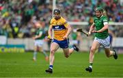 5 June 2022; Tony Kelly of Clare races clear of William O'Donoghue of Limerick during the Munster GAA Hurling Senior Championship Final match between Limerick and Clare at FBD Semple Stadium in Thurles, Tipperary. Photo by Brendan Moran/Sportsfile