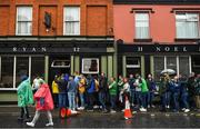 5 June 2022; Supporters take shelter from the rain in the town centre before the Munster GAA Hurling Senior Championship Final match between Limerick and Clare at FBD Semple Stadium in Thurles, Tipperary. Photo by Brendan Moran/Sportsfile