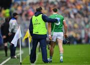 5 June 2022; Mike Casey of Limerick, with team doctor Dr James Ryan, as he leaves the field after being substituted during the Munster GAA Hurling Senior Championship Final match between Limerick and Clare at Semple Stadium in Thurles, Tipperary. Photo by Ray McManus/Sportsfile