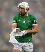 5 June 2022; Aaron Gillane of Limerick uses a towel to clean his hurley as he prepares to take a free during the Munster GAA Hurling Senior Championship Final match between Limerick and Clare at Semple Stadium in Thurles, Tipperary. Photo by Ray McManus/Sportsfile