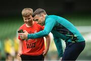 7 June 2022; Republic of Ireland's Seamus Coleman video calls his Everton club-mate Vitaliy Mykolenko, to speak to 12-year-old Ukrainian citizen Mattvii Rybkin, from Zhytomyr, who was invited to watch a Republic of Ireland training session at Aviva Stadium in Dublin. Photo by Stephen McCarthy/Sportsfile