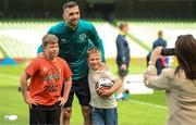 7 June 2022; Shane Duffy poses for a photograph with Ukrainian citizens Mattvii Rybkin, age 12, left, and Illia Sydorenko, age 8, both from Zhytomyr, during a Republic of Ireland training session at Aviva Stadium in Dublin. Photo by Stephen McCarthy/Sportsfile