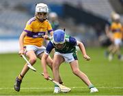 8 June 2022; David Lombard of St Pius X BNS is tackled by Joseph Davy of St Laurence's, Kilmacud, during the Corn Marino final at the Allianz Cumann na mBunscoil Hurling Finals in Croke Park, Dublin. Over 2,800 schools and 200,000 students are set to compete in the primary schools competition this year with finals taking place across the country. Allianz and Cumann na mBunscol are also gifting 500 footballs, 200 hurleys and 200 sliotars to schools across the country to welcome Ukrainian students into our national games and local communities. Photo by Piaras Ó Mídheach/Sportsfile