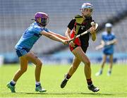 8 June 2022; Caoimhe Phelan of St Olaf's, Sandyford, in action against Lucy Clinch of Garran Mhuire, Goatstown, in the Corn Haughey final at the Allianz Cumann na mBunscoil Hurling Finals in Croke Park, Dublin. Over 2,800 schools and 200,000 students are set to compete in the primary schools competition this year with finals taking place across the country. Allianz and Cumann na mBunscol are also gifting 500 footballs, 200 hurleys and 200 sliotars to schools across the country to welcome Ukrainian students into our national games and local communities. Photo by Piaras Ó Mídheach/Sportsfile