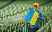 8 June 2022; Young Ukraine supporter Kirill Manzhosov, age 9, from Wicklow, puts out Ukraine flag banners on seating before the UEFA Nations League B group 1 match between Republic of Ireland and Ukraine at Aviva Stadium in Dublin. Photo by Seb Daly/Sportsfile