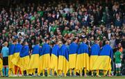 8 June 2022; Ukraine players stand for the national anthem wearing Ukranian flags before the UEFA Nations League B group 1 match between Republic of Ireland and Ukraine at Aviva Stadium in Dublin. Photo by Seb Daly/Sportsfile