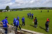 10 June 2022; The North West Warriors team, and the opening Northern Knights batsmen James McCollum and John Matchett take to the field before the Cricket Ireland Inter-Provincial Trophy match between North West Warriors and Northern Knights at Bready Cricket Club in Bready, Tyrone. Photo by Ramsey Cardy/Sportsfile