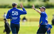 10 June 2022; Shane Getkate, left, and Craig Young of North West Warriors celebrate a wicket during the Cricket Ireland Inter-Provincial Trophy match between North West Warriors and Northern Knights at Bready Cricket Club in Bready, Tyrone. Photo by Ramsey Cardy/Sportsfile