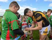 9 June 2022; In attendance at the GAA Hurling All-Ireland Senior Championship Series national launch at Loughmore-Castleiney GAA Club in Tipperary are is Richie Reid of Kilkenny signing autographs for young Loughmore-Castleiney GAA player Kyle Kelly. Photo by Brendan Moran/Sportsfile
