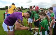 9 June 2022; In attendance at the GAA Hurling All-Ireland Senior Championship Series national launch at Loughmore-Castleiney GAA Club in Tipperary are is Lee Chin of Wexford signing autographs for young Loughmore-Castleiney GAA players. Photo by Brendan Moran/Sportsfile