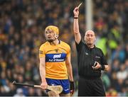 5 June 2022; Referee John Keenan shows a yellow card to David Fitzgerald of Clare during the Munster GAA Hurling Senior Championship Final match between Limerick and Clare at FBD Semple Stadium in Thurles, Tipperary. Photo by Piaras Ó Mídheach/Sportsfile