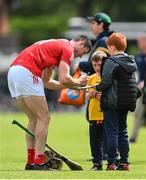 11 June 2022; Séamus Harnedy of Cork signs autographs after the GAA Hurling All-Ireland Senior Championship Preliminary Quarter-Final match between Antrim and Cork at Corrigan Park in Belfast. Photo by Ramsey Cardy/Sportsfile
