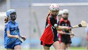 8 June 2022; Lily Walsh of St Olaf's, Sandyford, in action against Amaya Byrne of Garran Mhuire, Goatstown, during the Corn Haughey final at the Allianz Cumann na mBunscoil Hurling Finals in Croke Park, Dublin. Over 2,800 schools and 200,000 students are set to compete in the primary schools competition this year with finals taking place across the country. Allianz and Cumann na mBunscol are also gifting 500 footballs, 200 hurleys and 200 sliotars to schools across the country to welcome Ukrainian students into our national games and local communities. Photo by Piaras Ó Mídheach/Sportsfile