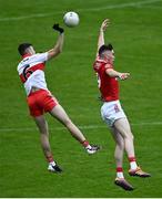 11 June 2022; Odhran Crozier of Derry in action against Colm Gillespie of Cork during the Electric Ireland GAA Football All-Ireland Minor Championship Quarter-Final match between Cork and Derry at MW Hire O'Moore Park in Portlaoise, Laois. Photo by David Fitzgerald/Sportsfile