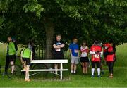 12 June 2022; Runners shelter from the rain before the Irish Runner 5 Mile incorporating the AAI National 5 Mile Championships at Phoenix Park in Dublin. Photo by Sam Barnes/Sportsfile