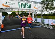 12 June 2022; Gillian Kavanagh of Gowran AC, Kilkenny, left, and Mary McHugh cross the finish line during the Irish Runner 5 Mile incorporating the AAI National 5 Mile Championships at Phoenix Park in Dublin. Photo by Sam Barnes/Sportsfile