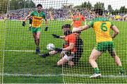 12 June 2022; Aidan Nugent of Armagh is fouled by Donegal goalkeeper Shaun Patton, resulting in a penalty for Armagh and black card for Shaun Patton, during the GAA Football All-Ireland Senior Championship Round 2 match between between Donegal and Armagh at St Tiernach's Park in Clones, Monaghan. Photo by Seb Daly/Sportsfile