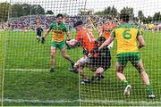 12 June 2022; Aidan Nugent of Armagh is fouled by Donegal goalkeeper Shaun Patton, resulting in a penalty for Armagh and black card for Shaun Patton, during the GAA Football All-Ireland Senior Championship Round 2 match between between Donegal and Armagh at St Tiernach's Park in Clones, Monaghan. Photo by Seb Daly/Sportsfile