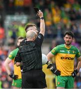 12 June 2022; Referee Brendan Cawley shows a black card to Donegal goalkeeper Shaun Patton during the GAA Football All-Ireland Senior Championship Round 2 match between between Donegal and Armagh at St Tiernach's Park in Clones, Monaghan. Photo by Seb Daly/Sportsfile