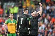 12 June 2022; Referee Brendan Cawley shows a black card to Donegal goalkeeper Shaun Patton during the GAA Football All-Ireland Senior Championship Round 2 match between between Donegal and Armagh at St Tiernach's Park in Clones, Monaghan. Photo by Seb Daly/Sportsfile