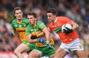 12 June 2022; Stefan Campbell of Armagh in action against Peadar Mogan of Donegal during the GAA Football All-Ireland Senior Championship Round 2 match between between Donegal and Armagh at St Tiernach's Park in Clones, Monaghan. Photo by Seb Daly/Sportsfile