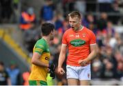 12 June 2022; Rian O'Neill of Armagh celebrates in front of Donegal's Brendan McCole after scoring his side's second goal via a penalty during the GAA Football All-Ireland Senior Championship Round 2 match between between Donegal and Armagh at St Tiernach's Park in Clones, Monaghan. Photo by Seb Daly/Sportsfile