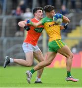 12 June 2022; Odhran McFadden Ferry of Donegal is tackled by Conor O'Neill of Armagh during the GAA Football All-Ireland Senior Championship Round 2 match between between Donegal and Armagh at St Tiernach's Park in Clones, Monaghan. Photo by Ramsey Cardy/Sportsfile