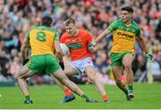 12 June 2022; Rian O'Neill of Armagh in action against Caolan McGonagle, left, and Odhran McFadden Ferry of Donegal during the GAA Football All-Ireland Senior Championship Round 2 match between between Donegal and Armagh at St Tiernach's Park in Clones, Monaghan. Photo by Ramsey Cardy/Sportsfile