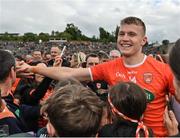 12 June 2022; Rian O'Neill of Armagh celebrates with supporters after his side's victory in the GAA Football All-Ireland Senior Championship Round 2 match between between Donegal and Armagh at St Tiernach's Park in Clones, Monaghan. Photo by Seb Daly/Sportsfile