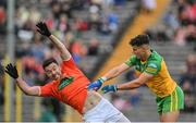 12 June 2022; Odhran McFadden Ferry of Donegal and Aidan Forker of Armagh tussle off the ball during the GAA Football All-Ireland Senior Championship Round 2 match between between Donegal and Armagh at St Tiernach's Park in Clones, Monaghan. Photo by Seb Daly/Sportsfile