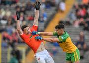12 June 2022; Odhran McFadden Ferry of Donegal and Aidan Forker of Armagh tussle off the ball during the GAA Football All-Ireland Senior Championship Round 2 match between between Donegal and Armagh at St Tiernach's Park in Clones, Monaghan. Photo by Seb Daly/Sportsfile
