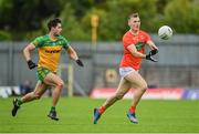 12 June 2022; Rian O'Neill of Armagh in action against Brendan McCole of Donegal during the GAA Football All-Ireland Senior Championship Round 2 match between between Donegal and Armagh at St Tiernach's Park in Clones, Monaghan. Photo by Seb Daly/Sportsfile