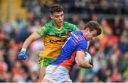 12 June 2022; Armagh goalkeeper Ethan Rafferty in action against Odhran McFadden Ferry of Donegal during the GAA Football All-Ireland Senior Championship Round 2 match between between Donegal and Armagh at St Tiernach's Park in Clones, Monaghan. Photo by Seb Daly/Sportsfile