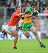 12 June 2022; Caolan McGonagle of Donegal in action against Stephen Sheridan of Armagh during the GAA Football All-Ireland Senior Championship Round 2 match between between Donegal and Armagh at St Tiernach's Park in Clones, Monaghan. Photo by Ramsey Cardy/Sportsfile