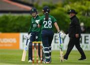 14 June 2022; Georgina Dempsey of Ireland, left, bumps gloves with teammate Jane Maguire as they close out their side's first innings during the Women's one day international match between Ireland and South Africa at Clontarf Cricket Club in Dublin. Photo by George Tewkesbury/Sportsfile