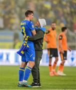 14 June 2022; A pitch invader with Illia Zabarnyi of Ukraine after the UEFA Nations League B group 1 match between Ukraine and Republic of Ireland at LKS Stadium in Lodz, Poland. Photo by Stephen McCarthy/Sportsfile