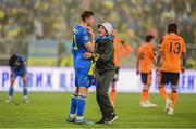 14 June 2022; A pitch invader with Illia Zabarnyi of Ukraine after the UEFA Nations League B group 1 match between Ukraine and Republic of Ireland at LKS Stadium in Lodz, Poland. Photo by Stephen McCarthy/Sportsfile
