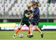 14 June 2022; Republic of Ireland STATSports analyst Andrew Morrissey assists Nathan Collins of Republic of Ireland in his warm-up before the UEFA Nations League B group 1 match between Ukraine and Republic of Ireland at LKS Stadium in Lodz, Poland. Photo by Stephen McCarthy/Sportsfile