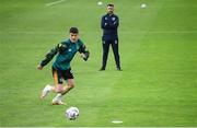 14 June 2022; Republic of Ireland chartered physiotherapist Kevin Mulholland watches on as Darragh Lenihan of Republic of Ireland warms up before the UEFA Nations League B group 1 match between Ukraine and Republic of Ireland at LKS Stadium in Lodz, Poland. Photo by Stephen McCarthy/Sportsfile