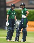 14 June 2022; Sophie MacMahon of Ireland with team mate Gaby Lewis during the Women's one day international match between Ireland and South Africa at Clontarf Cricket Club in Dublin. Photo by George Tewkesbury/Sportsfile