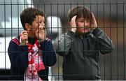 17 June 2022; Young Shelbourne supporters watch on through a fence during the SSE Airtricity League Premier Division match between Bohemians and Shelbourne at Dalymount Park in Dublin. Photo by Harry Murphy/Sportsfile