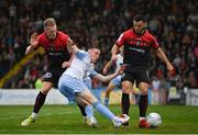 17 June 2022; Jack Moylan of Shelbourne has a shot on goal under pressure from Ciarán Kelly and Jordan Doherty of Bohemians during the SSE Airtricity League Premier Division match between Bohemians and Shelbourne at Dalymount Park in Dublin. Photo by Harry Murphy/Sportsfile