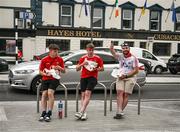 18 June 2022; Cork supporters, from left, Fin O'Donovan, Darren Daly and Michael Veal, all from Skibereen, enjoy a snack outside Hayes Hotel in Liberty Square ahead of the GAA Hurling All-Ireland Senior Championship Quarter-Final match between Galway and Cork at the FBD Semple Stadium in Thurles, Tipperary. Photo by Ray McManus/Sportsfile