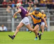 18 June 2022; Wexford full-back Liam Ryan pass the sliotar back under pressure from Shane O'Donnell of Clare during the GAA Hurling All-Ireland Senior Championship Quarter-Final match between Clare and Wexford at the FBD Semple Stadium in Thurles, Tipperary. Photo by Ray McManus/Sportsfile