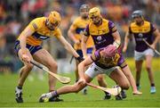 18 June 2022; Paudie Foley of Wexford is tackled by David Fitzgerald of Clare during the GAA Hurling All-Ireland Senior Championship Quarter-Final match between Clare and Wexford at the FBD Semple Stadium in Thurles, Tipperary. Photo by Ray McManus/Sportsfile