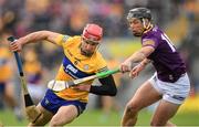 18 June 2022; John Conlon of Clare is tackled by Conor McDonald of Wexford during the GAA Hurling All-Ireland Senior Championship Quarter-Final match between Clare and Wexford at the FBD Semple Stadium in Thurles, Tipperary. Photo by Ray McManus/Sportsfile