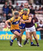 18 June 2022; Ian Galvin of Clare in action against Matthew O'Hanlon of Wexford during the GAA Hurling All-Ireland Senior Championship Quarter-Final match between Clare and Wexford at the FBD Semple Stadium in Thurles, Tipperary. Photo by Daire Brennan/Sportsfile