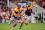 18 June 2022; Ian Galvin of Clare in action against Matthew O'Hanlon of Wexford during the GAA Hurling All-Ireland Senior Championship Quarter-Final match between Clare and Wexford at the FBD Semple Stadium in Thurles, Tipperary. Photo by Daire Brennan/Sportsfile